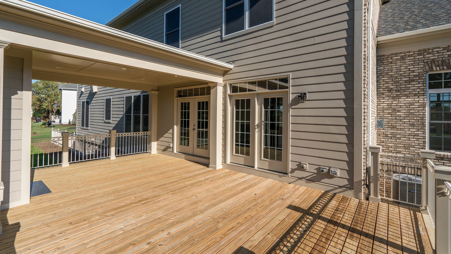 The deck and rear elevation of the Grayson on Fallsgate Homesite 4. Some optional features shown.