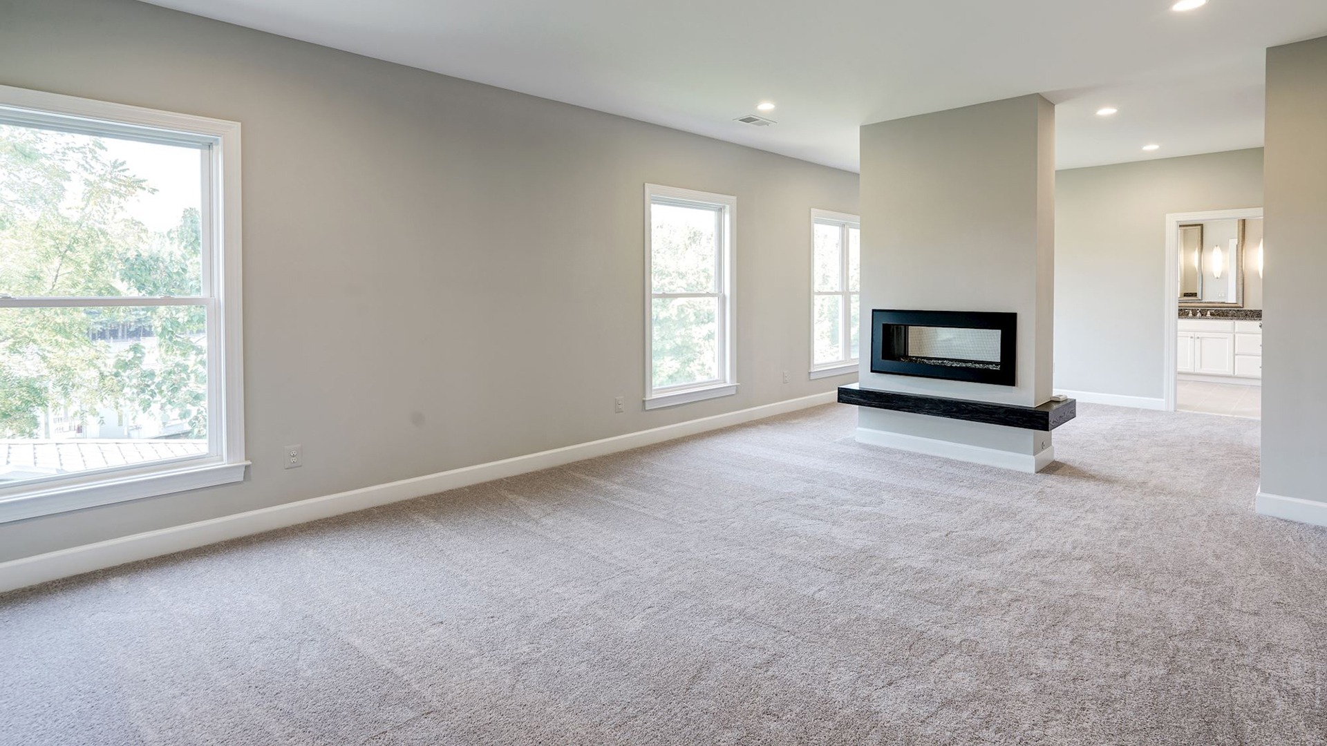 The Owner's Bedroom and Sitting Room with 2-sided Fireplace in the Grayson on Fallsgate Homesite 4. Some optional features shown.