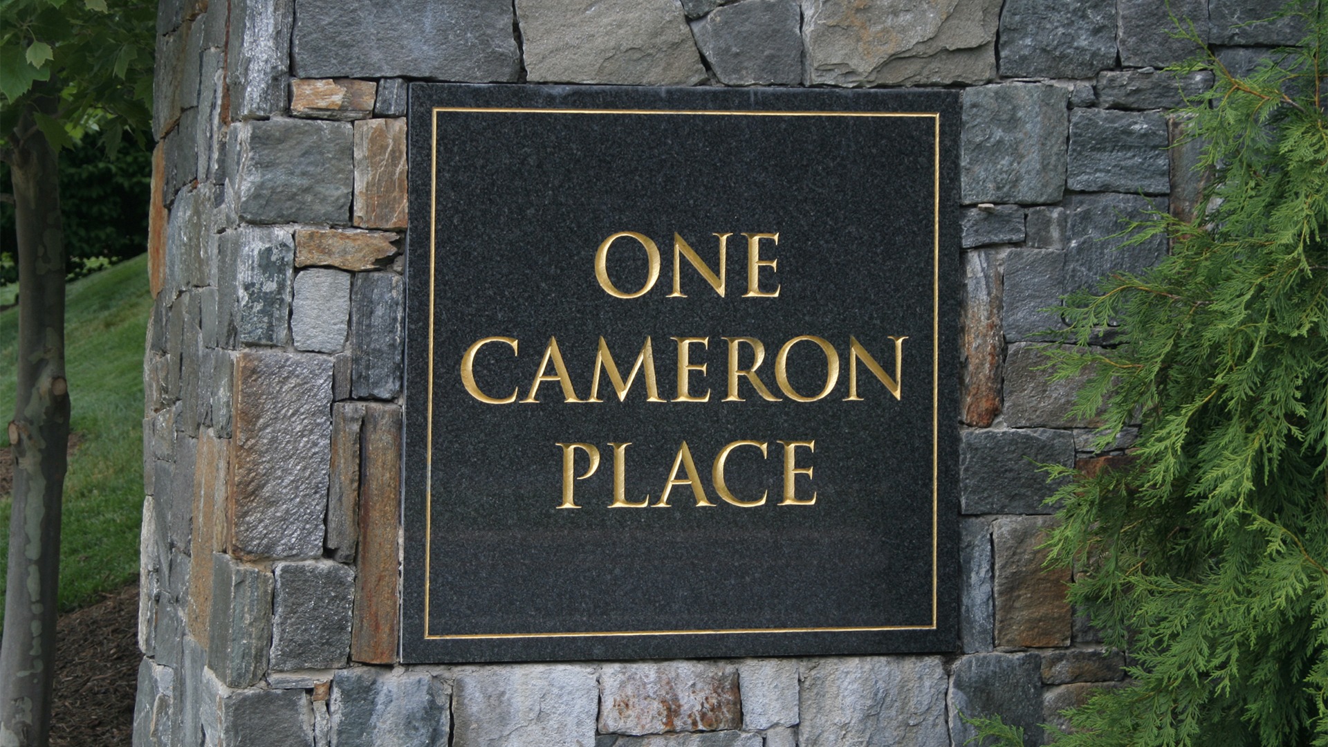 The plaque on the entrance feature at One Cameron Place.