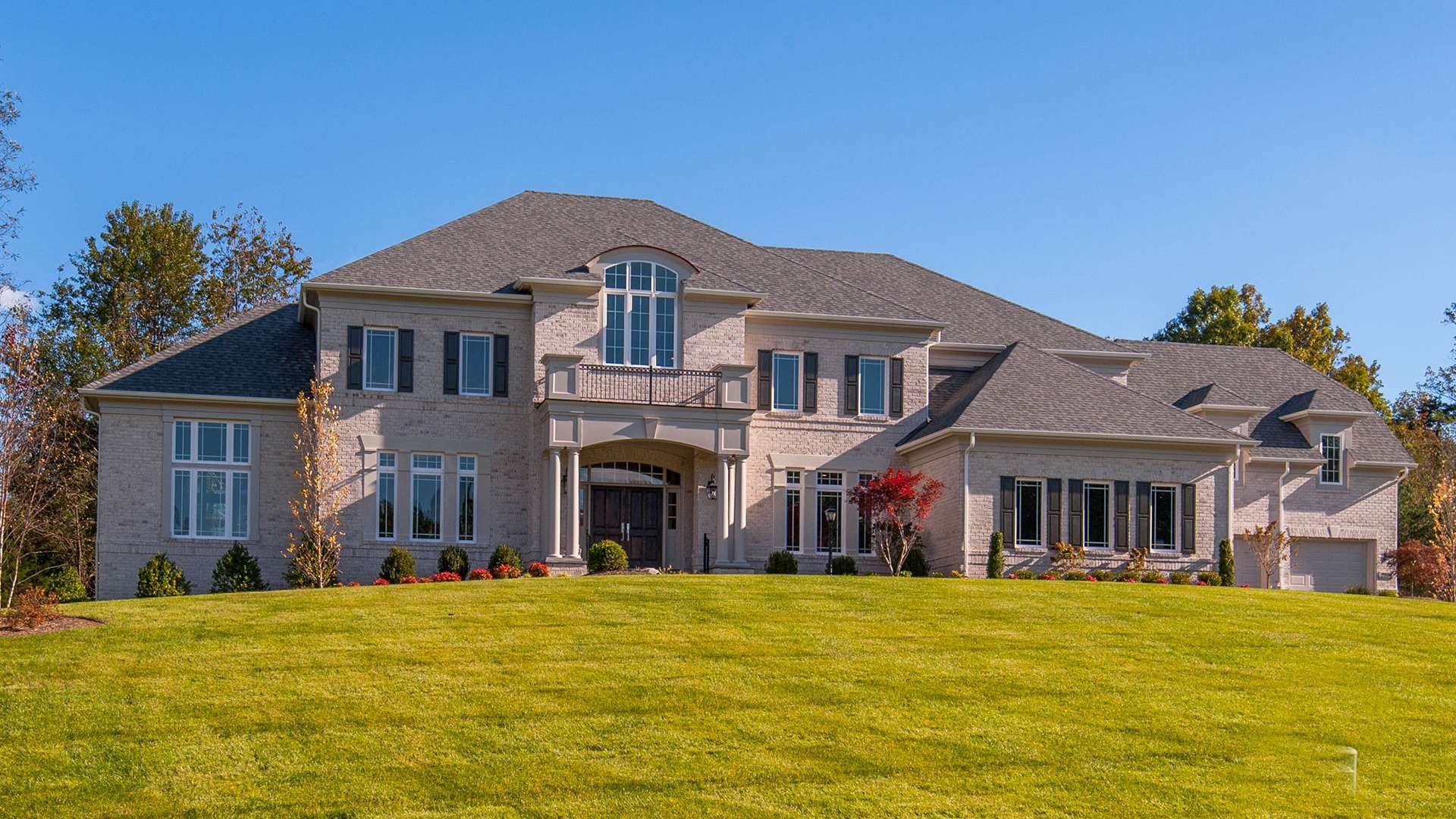 An all brick elevation with four car garage.