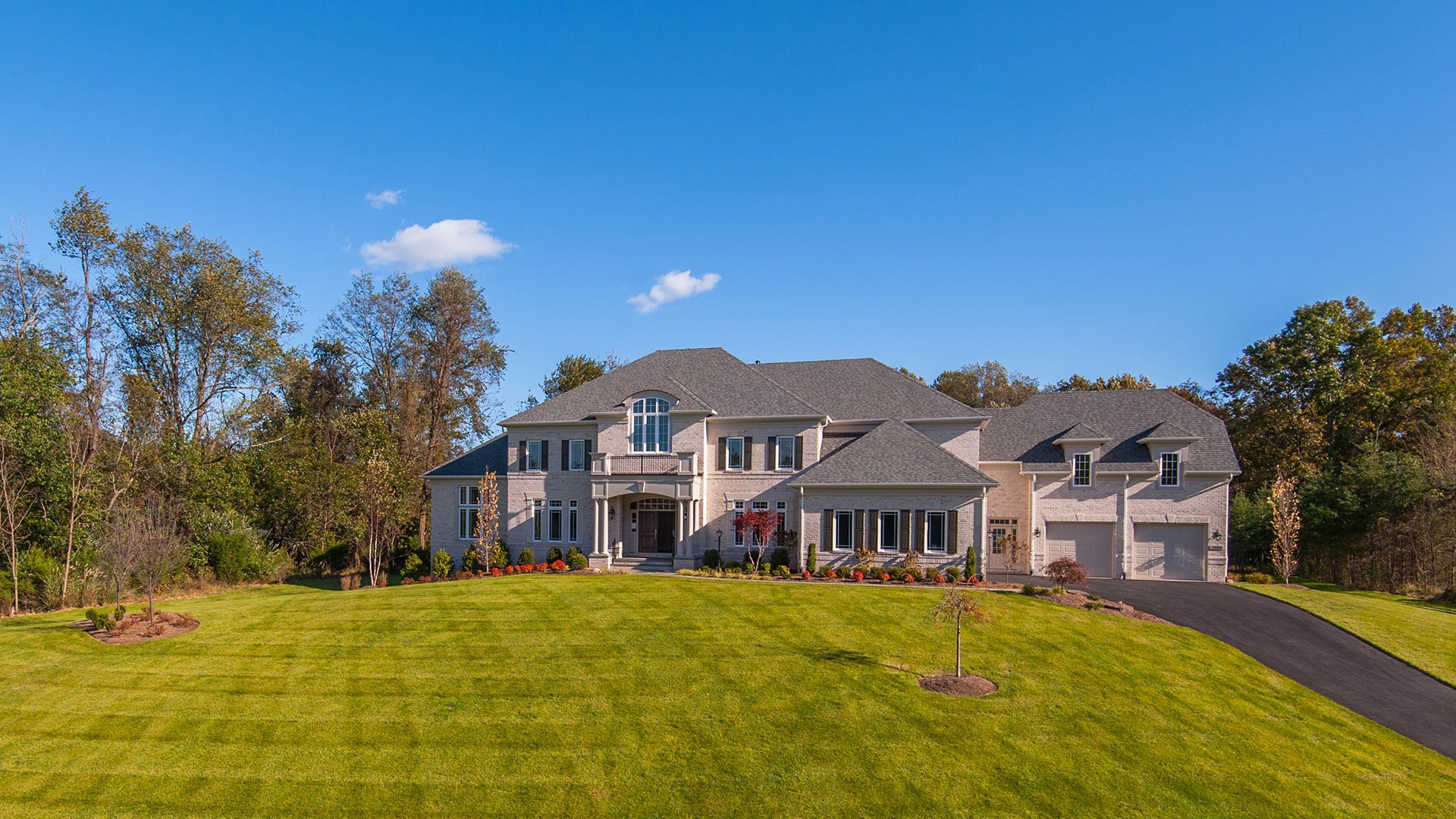 An all brick elevation with four car garage.