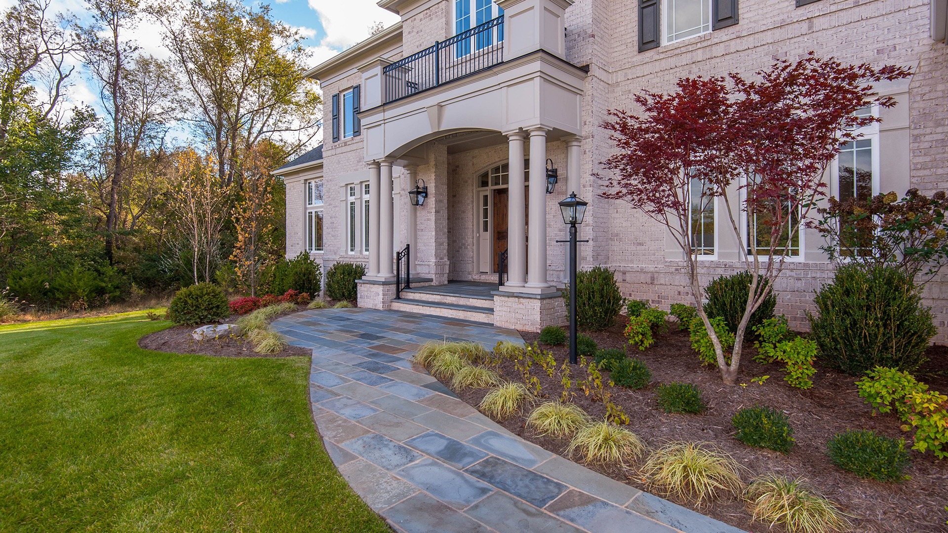 The stone leadwalk to the impressive front doors.