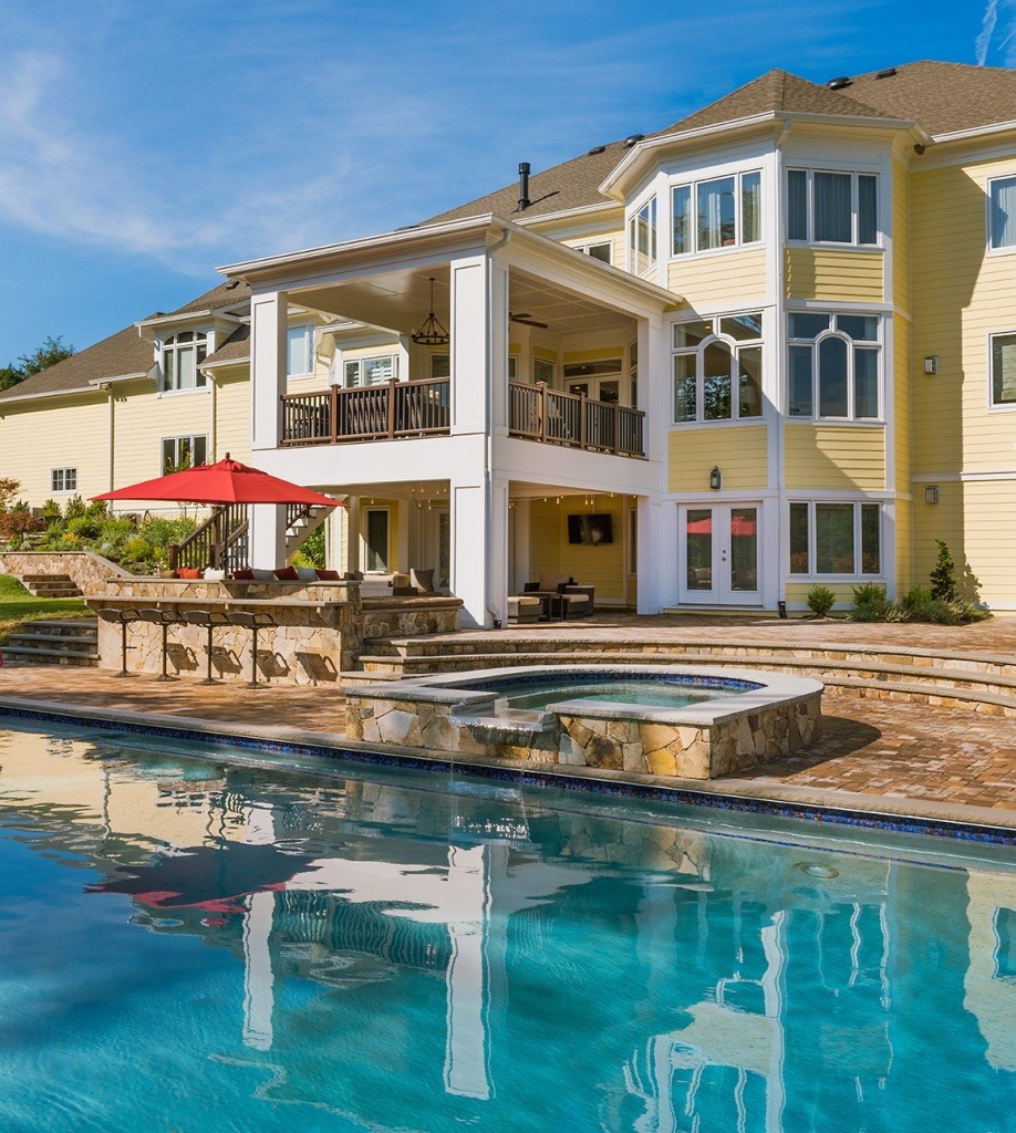 A custom Pool, with spa, outdoor living space, and Lanai on a Gulick | One home in Great Falls. ©Hoachlander Davis Photography