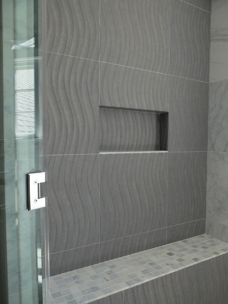 A shower with "wave", patterned tile.